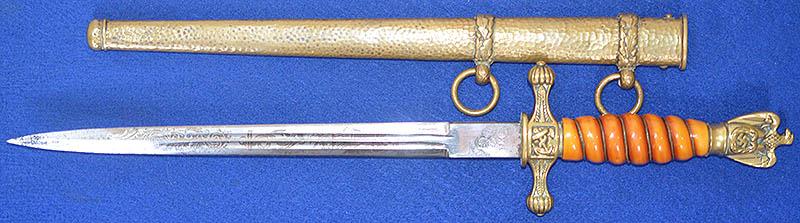 THIRD REICH NAVAL OFFICERS DAGGER BY WKC WITH SAILING SHIP BLADE,ORANGE GRIP AND HAMMERED SCABBARD.