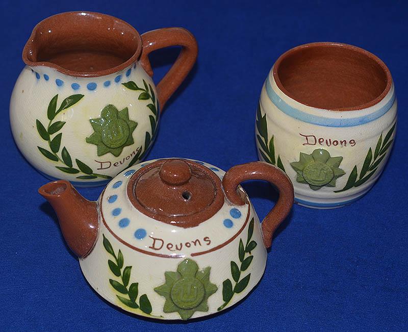 TORQUAY TYPE POTTERY TEA SET OF THE DEVON REGMENT.