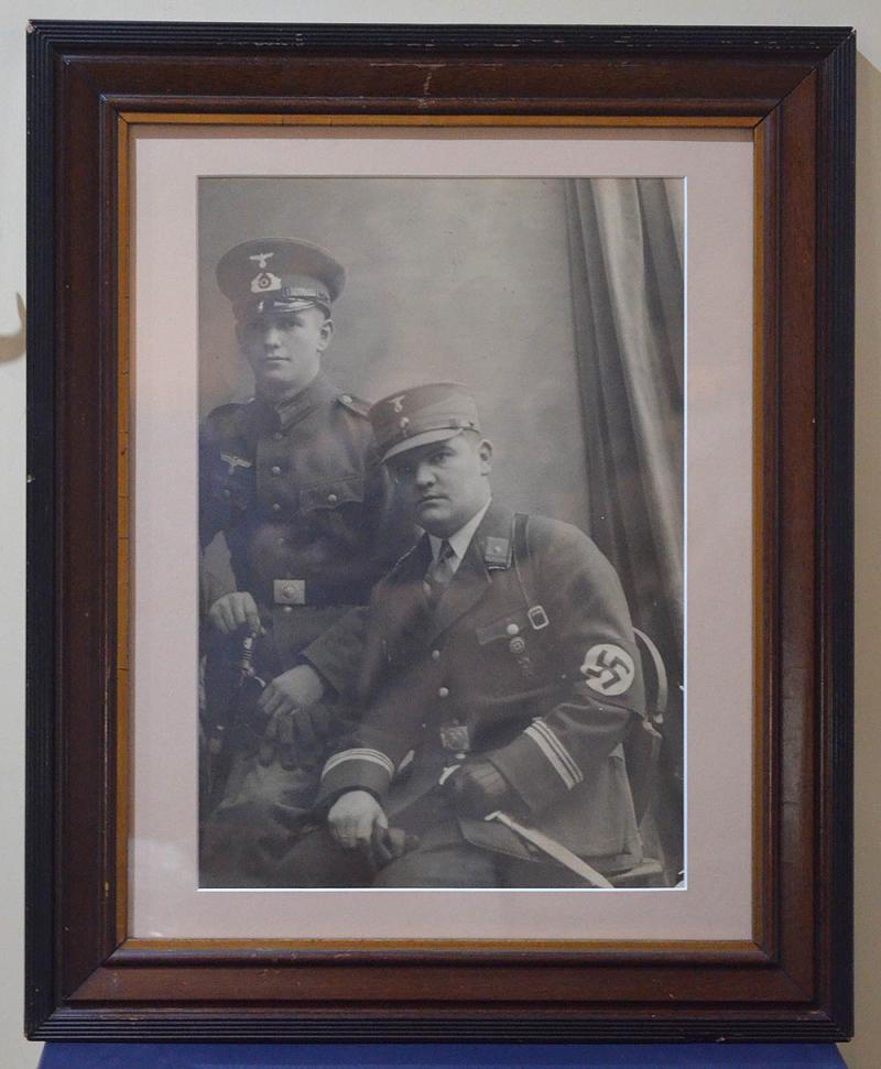 VERY LARGE FRAMED PHOTOGRAH OF SA MAN WITH DAGGER & GOLD PARTY BADGE.