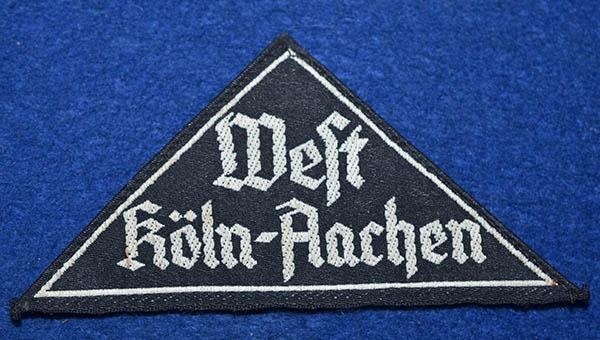 BDM DISTRICT TRIANGULAR BADGE.