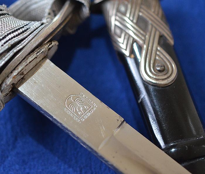 SS OFFICERS SWORD BY KREBS COMPLETE WITH SS KNOT AND BLACK LEATHER HANGER.