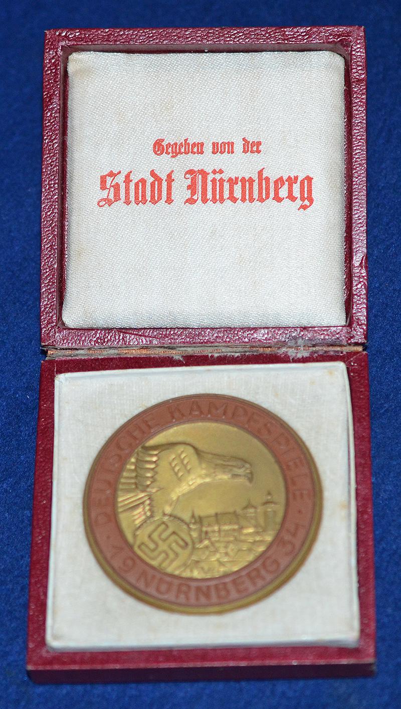 NSDAP 1934 COMEMORATIVE PLAQUETTE FOR THE NURNBERG RALLY COMPETITIONS WITH ORIGINAL PRESENTATION BOX.