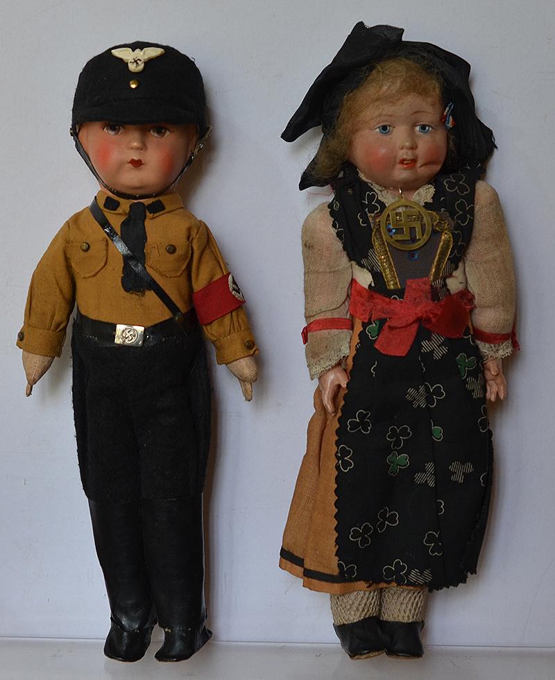 PAIR OF 1930'S THIRD REICH DOLLS, THE MALE DOLL IS DRESSED AS  AN SS MAN, THE FEMALE DOLL IS DRESSED IN BAVERIAN COSTUME DECORATED WITH SWASTIKA.