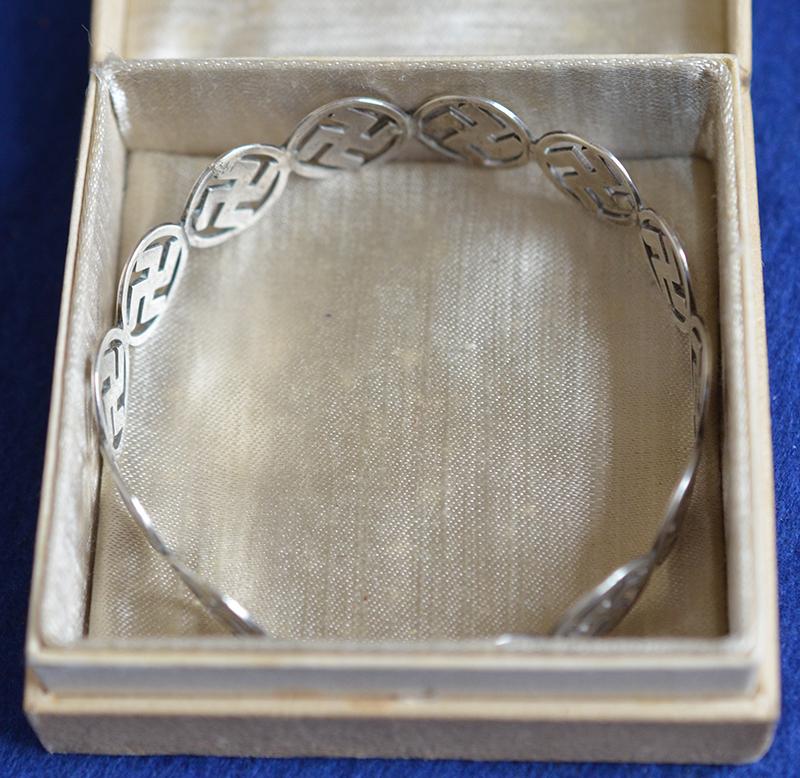 BRITISH 1920'S SILVER SWASTIKA DECORATED BANGLE COMPLETE WITH BOX.