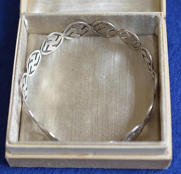BRITISH 1920'S SILVER SWASTIKA DECORATED BANGLE COMPLETE WITH BOX.