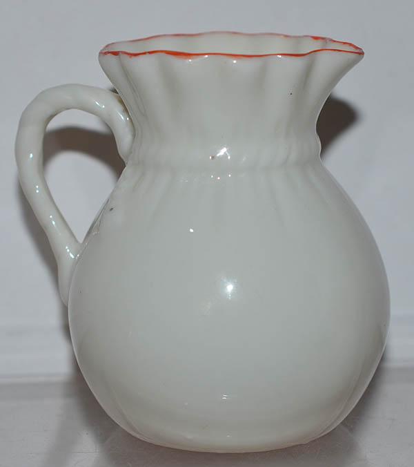 BRITISH CREAM JUG DEPICTING A CAT DECORATED WITH SWASTIKA.