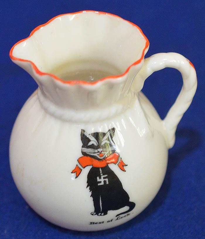 BRITISH CREAM JUG DEPICTING A CAT DECORATED WITH SWASTIKA.
